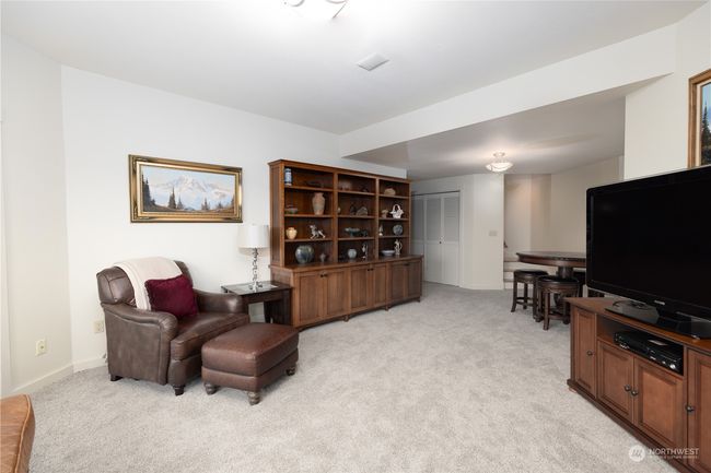 Family room looking toward stairs and hallway to bedrooms, bath, utility room, and storage | Image 36