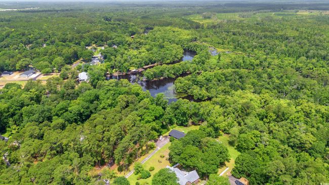 Aerial view of property's location featuring a forest and a large body of water | Image 37