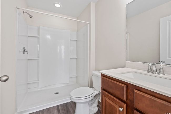 Bathroom with vanity, a shower, and wood finished floors | Image 4
