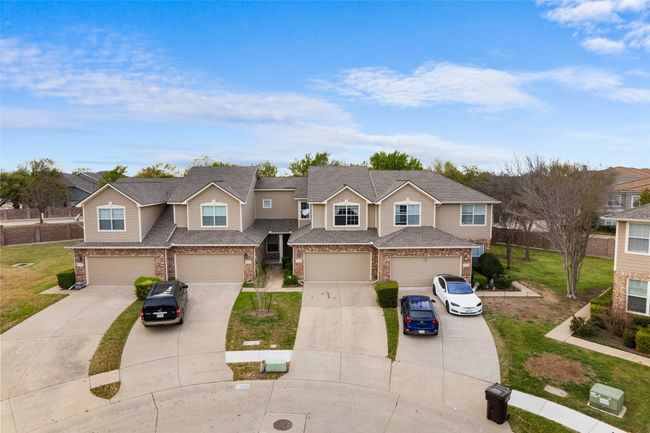 View of front of property with driveway, a garage, brick siding, and roof with shingles | Image 27