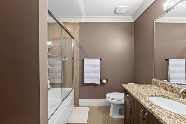 Bathroom featuring tile patterned flooring, vanity, toilet, baseboards, and bath / shower combo with glass door | Image 29