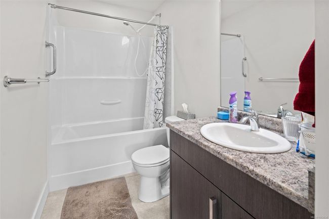 Bathroom featuring vanity and shower / bath combination with curtain | Image 46