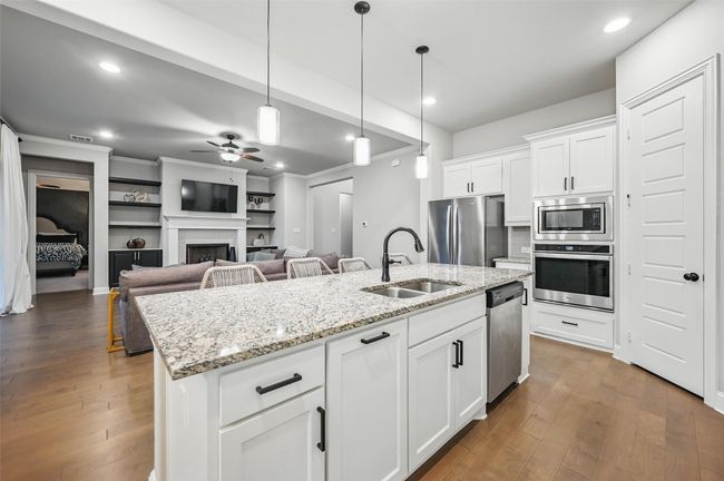 Kitchen with appliances with stainless steel finishes, ceiling fan, dark wood-style flooring, pendant lighting, and recessed lighting | Image 15