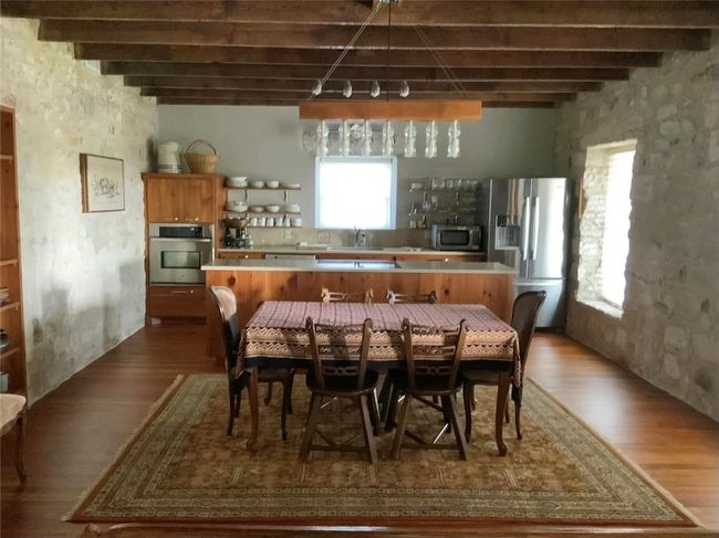 Open concept kitchen, dining and living room. | Image 4