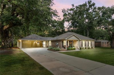 Single story home with a garage and a lawn | Image 1