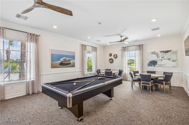 Game room with ceiling fan, crown molding, plenty of natural light, and carpet | Image 10