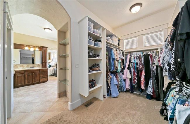Spacious closet featuring arched walkways and light tile patterned flooring | Image 23