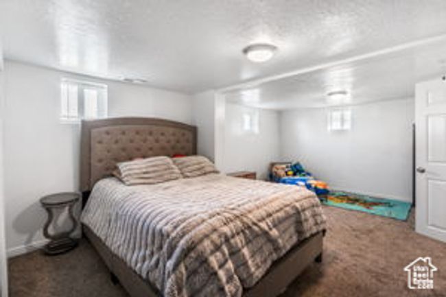 Carpeted bedroom featuring baseboards and a textured ceiling | Image 20