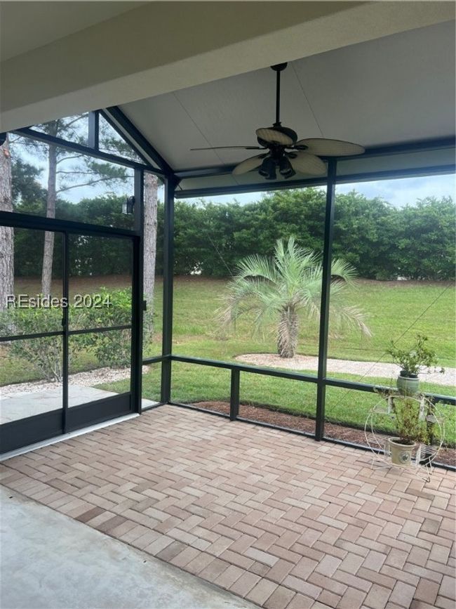 Unfurnished sunroom with plenty of natural light, ceiling fan, and vaulted ceiling | Image 30