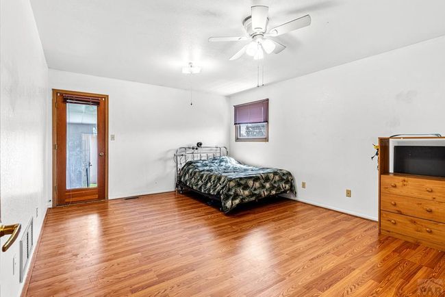 primary bedroom, exit to back yard, newer laminat | Image 12