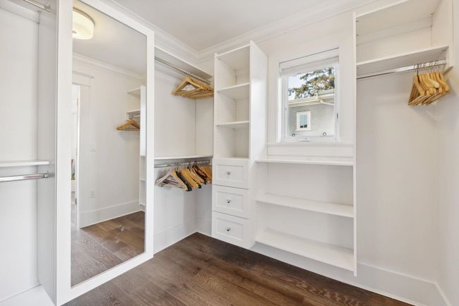 Spacious closet featuring dark wood-type flooring | Image 13