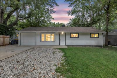 Ranch-style house with a garage and a yard | Image 1