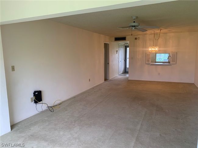 Living Room with carpet, ceiling fan and Chandelier | Image 6