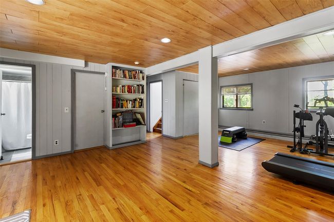Exercise room featuring wood ceiling, plenty of natural light, and light wood-style floors | Image 16