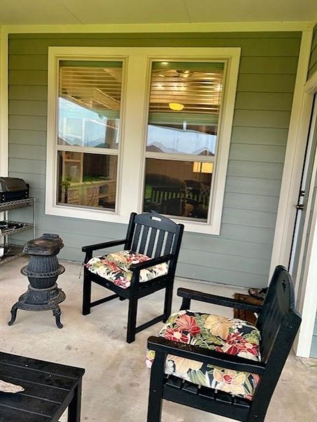 Enjoy the inviting charm of this home's beautifully maintained backyard from your roofed patio. | Image 26