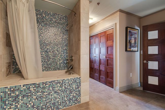 Large tub shower combo in bathroom #2 which also has hall entrance for guests. | Image 13