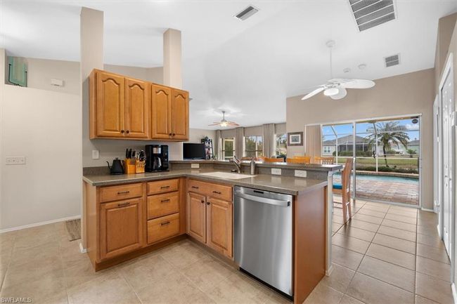 Kitchen with visible vents, stainless steel dishwasher, and a sink | Image 17