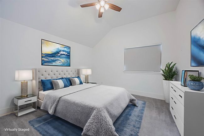 Bedroom featuring light colored carpet, vaulted ceiling, and a ceiling fan | Image 28