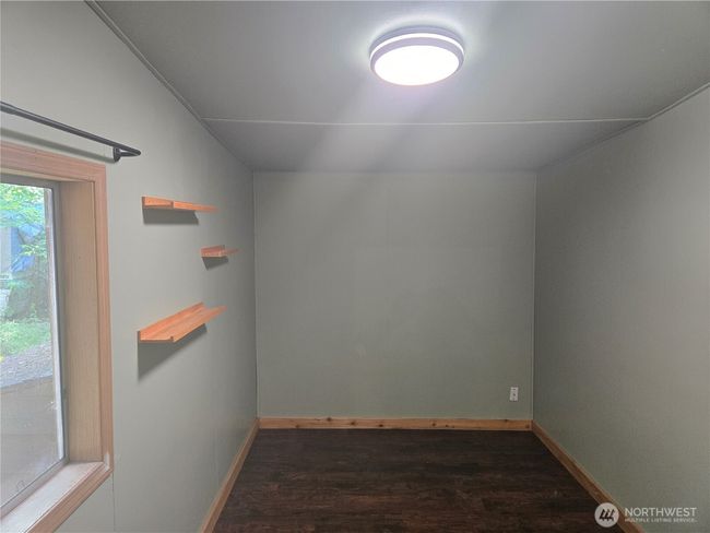 The second bedroom has new flooring and custom shelving. | Image 17