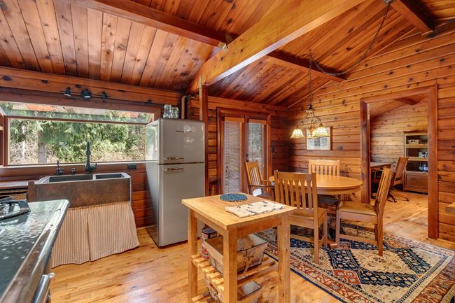 Dining area featuring light wood-style floors and wood ceiling | Image 11