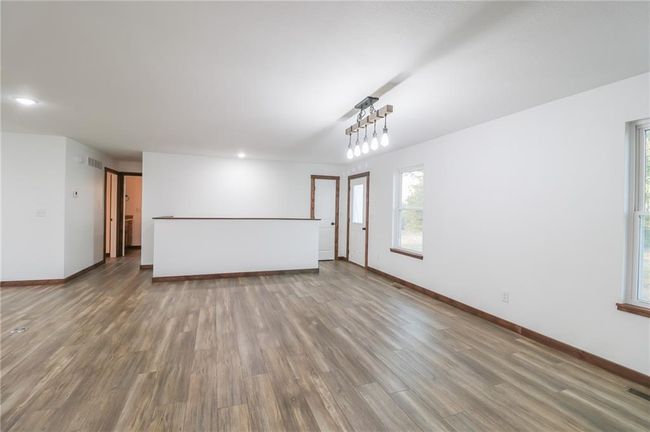 Unfurnished living room with wood-type flooring | Image 6