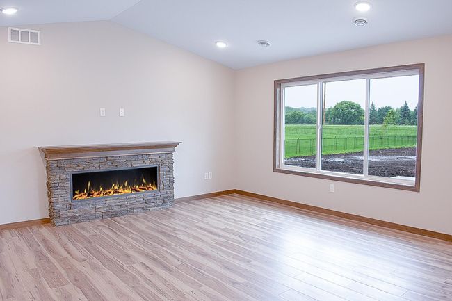 Living room highlighted with a stone surrounded Electric Fireplace | Image 7