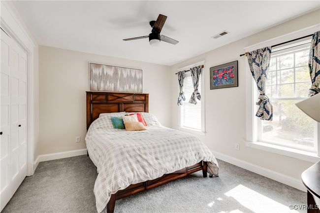 Bedroom featuring baseboards, visible vents, and carpet | Image 33