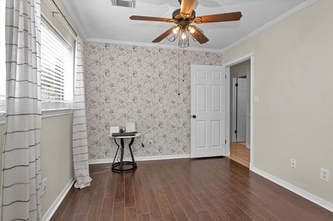 Elegant and stylish wallpaper adds a pop of flare to this secondary bedroom. | Image 26