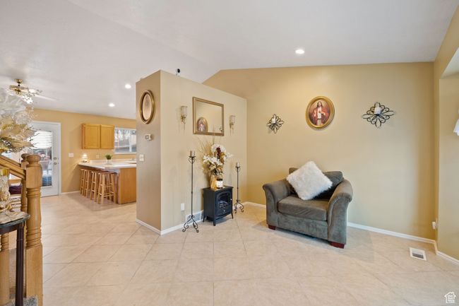 Sitting room with lofted ceiling, light tile patterned floors, and ceiling fan | Image 8