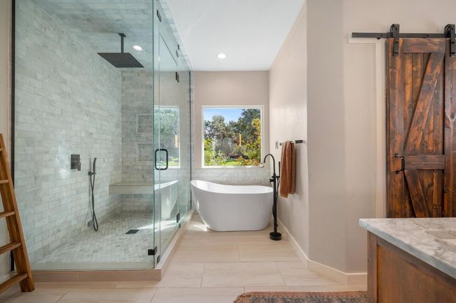 Full bath featuring vanity, a freestanding tub, baseboards, and a shower stall | Image 18