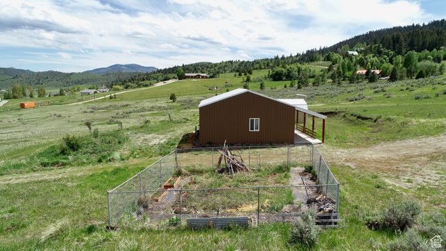 Aerial view of sparsely populated area featuring a mountain backdrop | Image 11