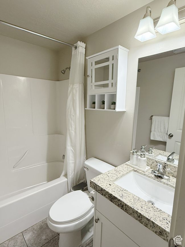 Full bathroom with shower / tub combo, vanity, and tile patterned flooring | Image 8