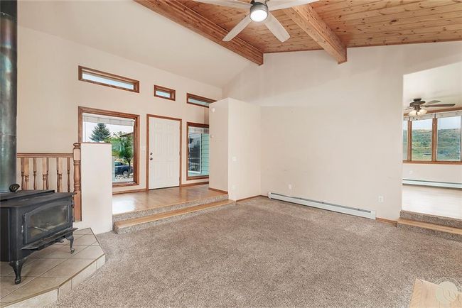 Living room with vaulted ceiling view to dining room and to front door | Image 8