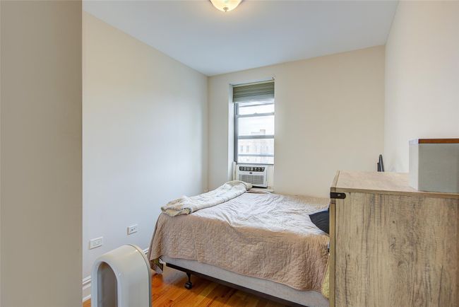Bedroom featuring cooling unit and wood finished floors | Image 7