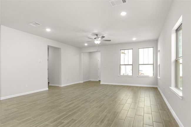 Empty room featuring visible vents, ceiling fan, light wood-type flooring, and recessed lighting | Image 8