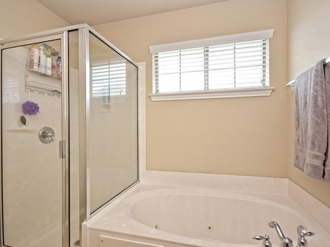 Full bathroom with a shower stall and a tub with jets | Image 15