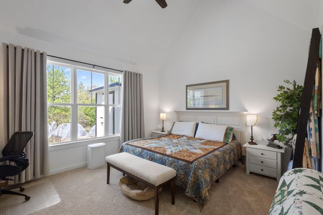 Carpeted bedroom featuring a ceiling fan and lofted ceiling | Image 22