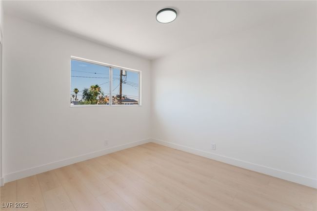 Spare room with wood finished floors and baseboards | Image 44
