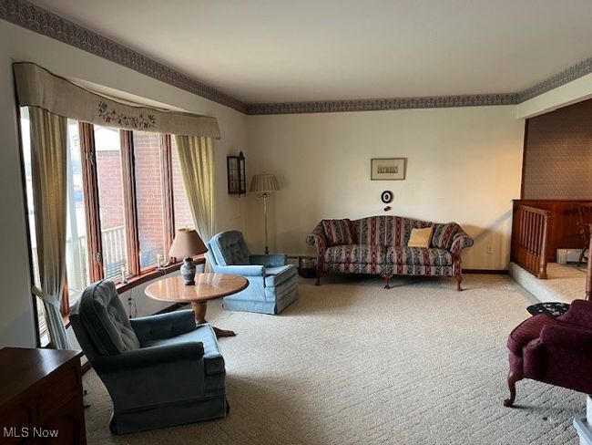 Living room featuring bay window open into dining area | Image 7