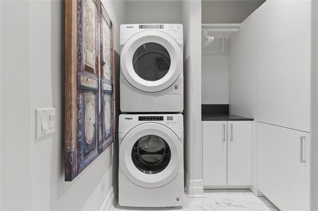 [Utility Room]Thoughtfully designed with custom cabinetry, full size washer and dryer convey unit | Image 29