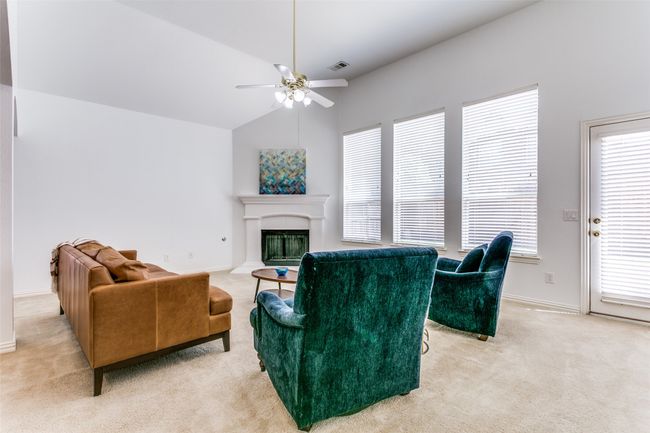 The tall windows offer ample amount of light in this comfortable living area. | Image 10