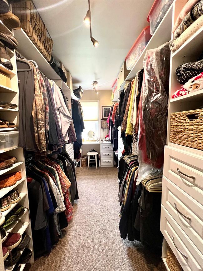 Walk in closet featuring built in organizers | Image 21