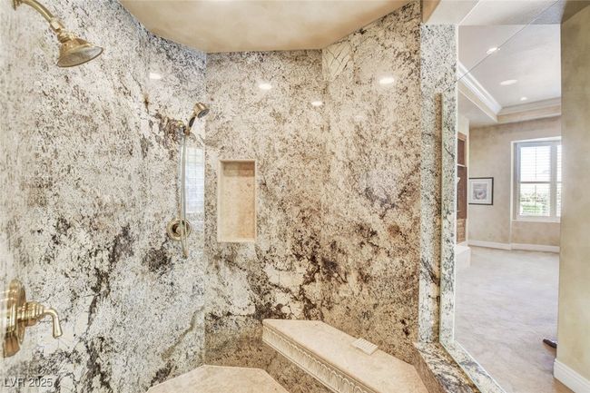 Bathroom with ornamental molding, a tile shower, and baseboards | Image 33