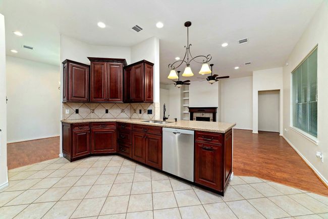 Become the host of the night with a kitchen that connects seamlessly to the breakfast area, bar, family room, and dining room—offering the perfect flow for effortless entertaining and everyday living. | Image 14