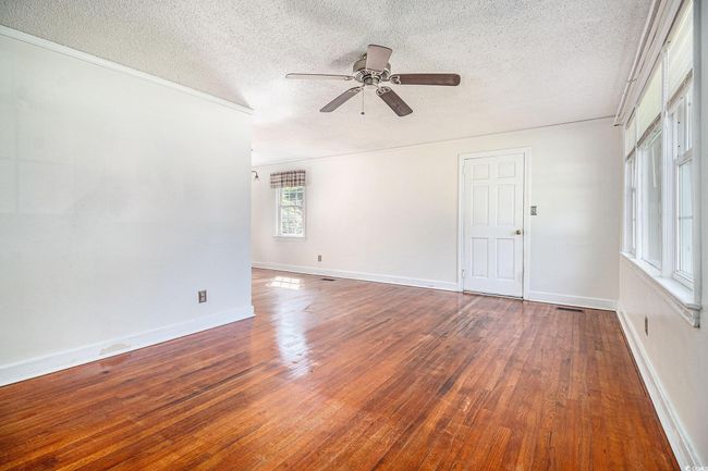 Unfurnished room with a textured ceiling, ceiling fan, and hardwood / wood-style flooring | Image 8