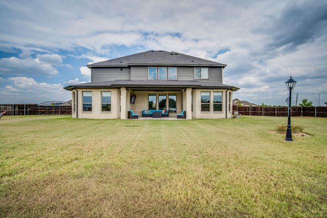 Rear view of property featuring an outdoor living space, a patio, and a yard | Image 35