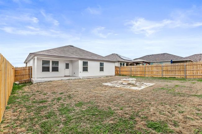 Back of house featuring a patio, a fenced backyard, and a fire pit | Image 16