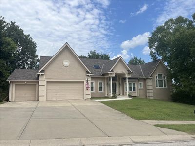 View of front of house with a garage and a front lawn | Image 1