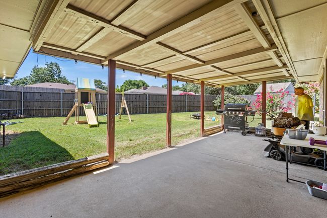 Fenced backyard with area for grilling, a patio, and a playground | Image 25