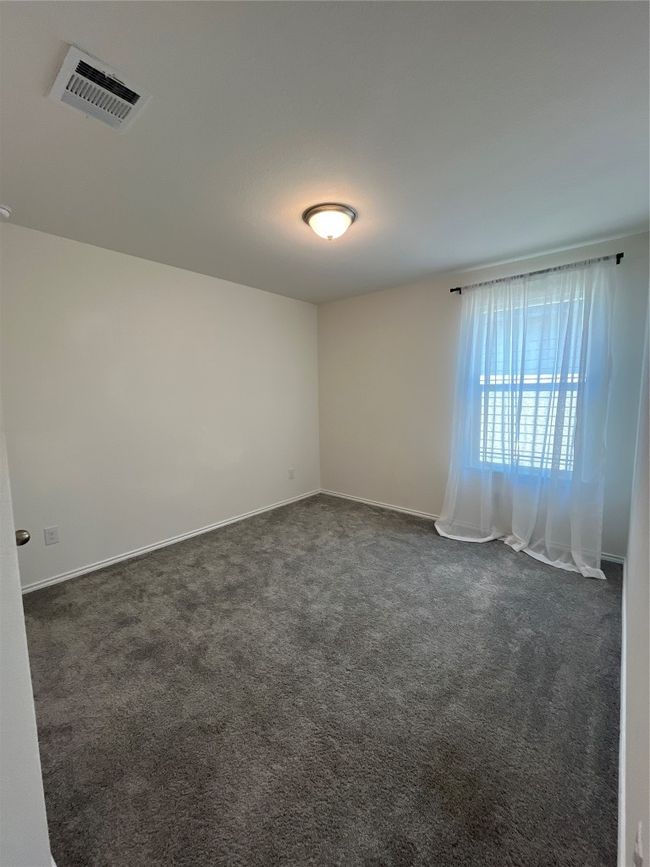 Unfurnished room featuring baseboards, visible vents, and dark colored carpet | Image 23